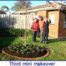 Three people standing in front of a yard with a tree in the middle.