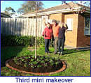 Three people standing in front of a yard with a tree in the middle.