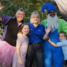 A group of people posing for a picture in costumes. [Keywords: costumes]