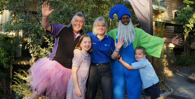 A group of people posing for a picture in costumes. [Keywords: costumes]