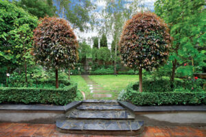 A stylish brick walkway leading to a garden.