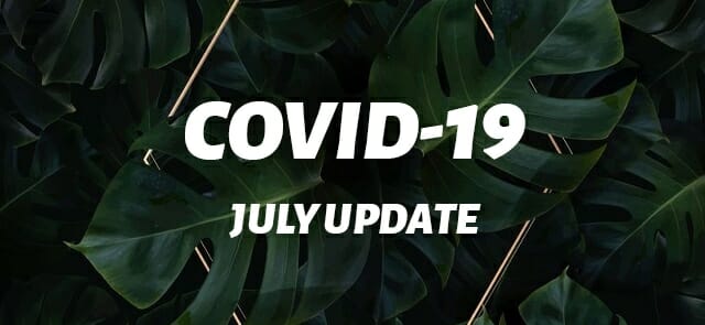 Text reading "July COVID-19 update" overlaid on a background of lush green leaves.