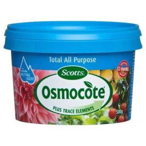 A blue container of Osmocote Controlled Release Fertiliser: Fruit, Citrus, Trees & Shrubs 500g with images of flowers and fruits on the label. Perfect for Fruit Citrus Trees and Shrubs, it includes a hydraulic wetting agent and provides 12 months of nourishment.