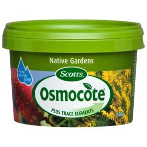 A green container of Osmocote Controlled Release Fertiliser: Fruit, Citrus, Trees & Shrubs 500g, labeled "Plus Trace Elements," with an image of flowers on the packaging. Ideal for shrubs and fruit citrus trees.