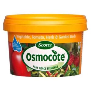 Orange container of Osmocote Controlled Release Fertiliser: Fruit, Citrus, Trees & Shrubs 500g, labeled for use on vegetable, tomato, herb, garden beds, and fruit citrus trees. Capacity: 500 grams.