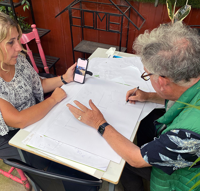 Chris helps a customer with a garden design