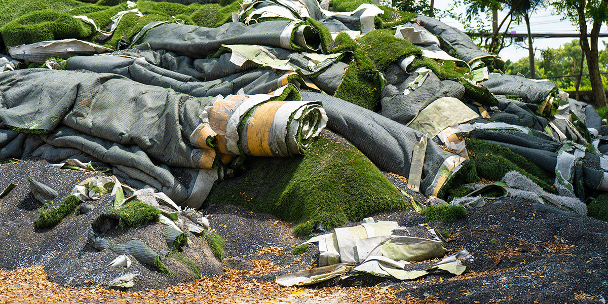 Piles of old fake grass ready to be thrown out