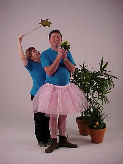A man and a woman dressed in tutu and holding a wand.