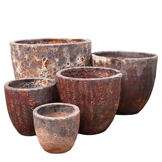 A group of Seafoam Bronte Planter Copper rustic brown pots for feature plants