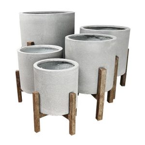 five different sized feature pots for plants in cement grey colour with wooden brown leg stands