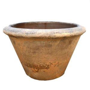 A large terra cotta planter on a white background. Terracotta squatcono planter pot orange rustic coloured for feature plants