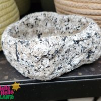 A Dart Stone Bowl 14x10x6cm sitting on top of a shelf perfect for small plants