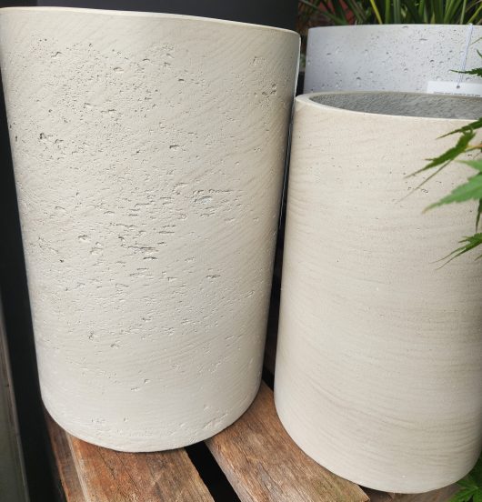 Two Grampians Straight Cylinder Cement S 24x35cm planters sitting on a wooden table.