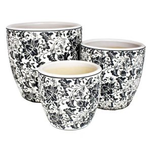A set of three different sized plant pots with saucers black and white floral design