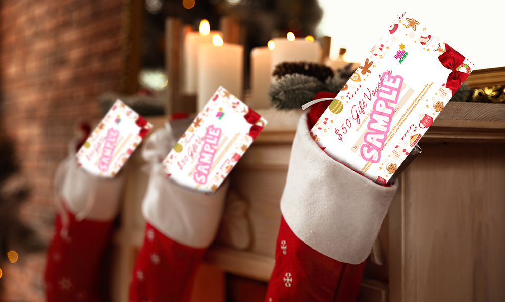 Christmas stockings hanging on a fireplace with candles. Stuffer stuffed with vouchers