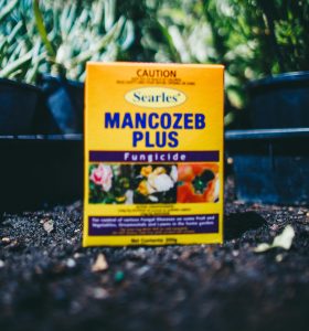 A box of Searles Mancozeb Plus Fungicide 200g sitting on the ground.