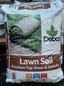 A 25L bag of Debco Lawn Soil 25L, labeled as premium top-dress and underlay soil. The packaging showcases a rolled-up piece of turf and highlights features like slow-release fertilizer.