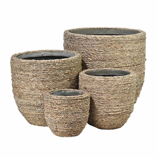 Four textured wicker baskets of varying sizes are stacked together on a white background, complemented by the Urban Grass Egg Pot Grass S (17x15cm) to create a natural yet modern vibe.