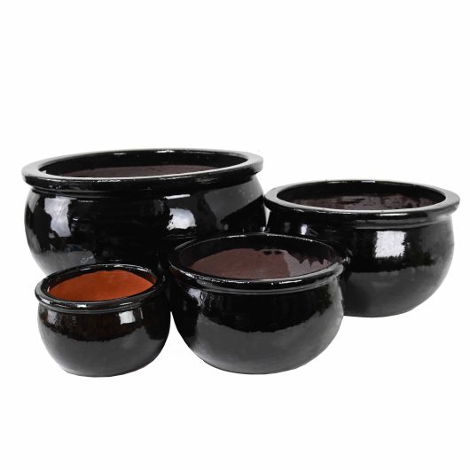 A Glazed Flat-Rim Bowl Blue XL 46x26cm (Copy) is placed on a white background alongside three other black ceramic bowls of varying sizes.